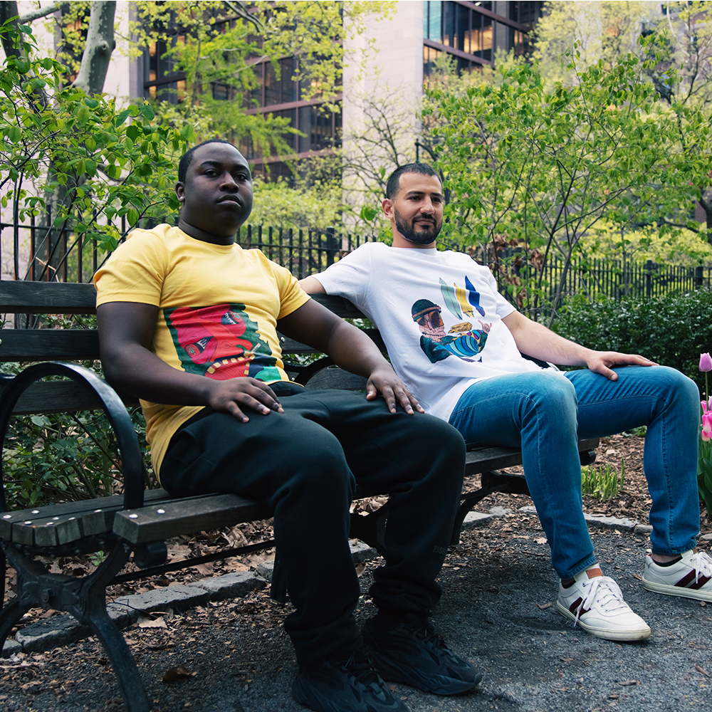 SAX OnPoint Pacifier maize yellow shirt and Choose Ur Weapon white shirt on models sitting on a bench