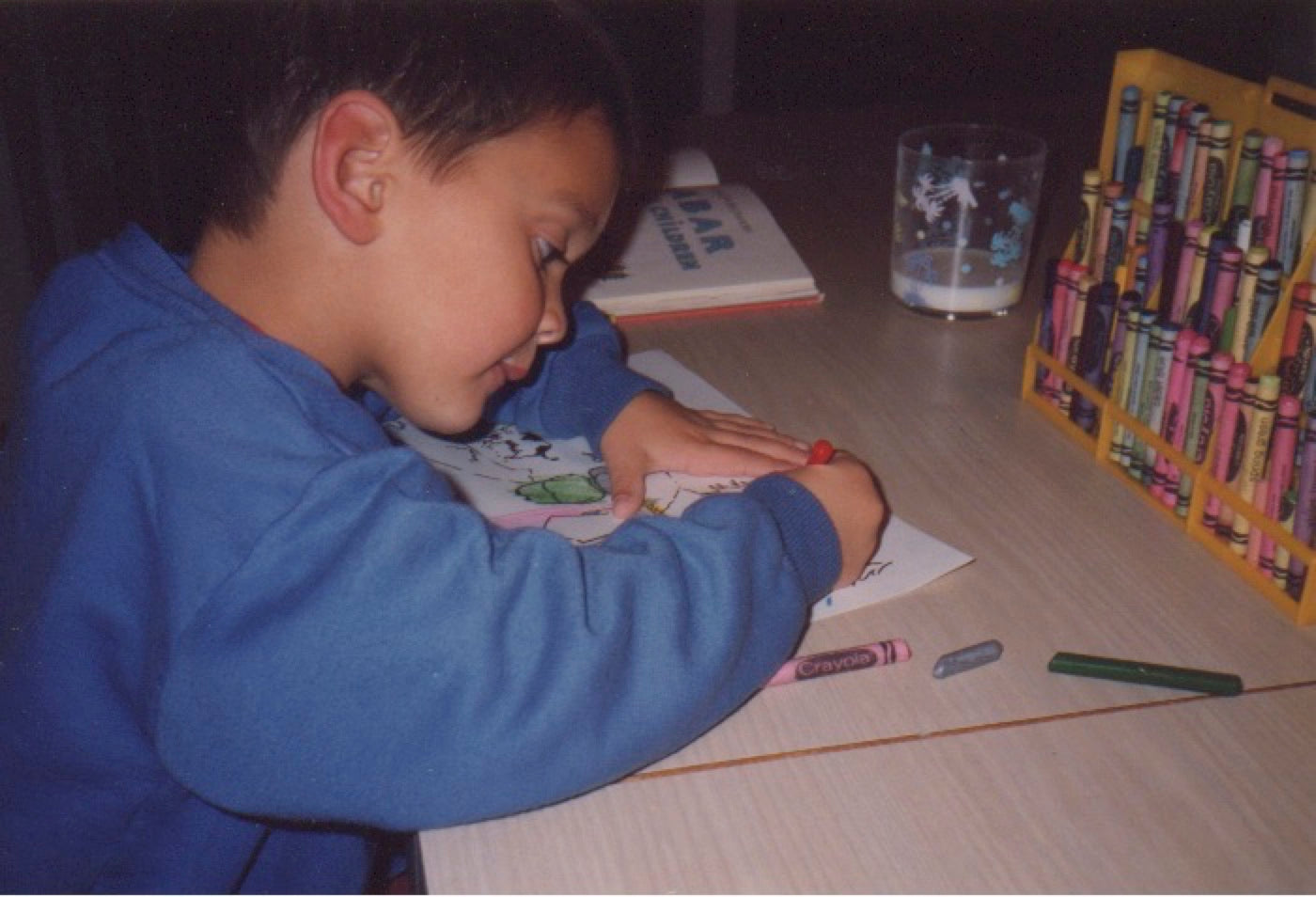 Sax Leader as a child drawing with crayons